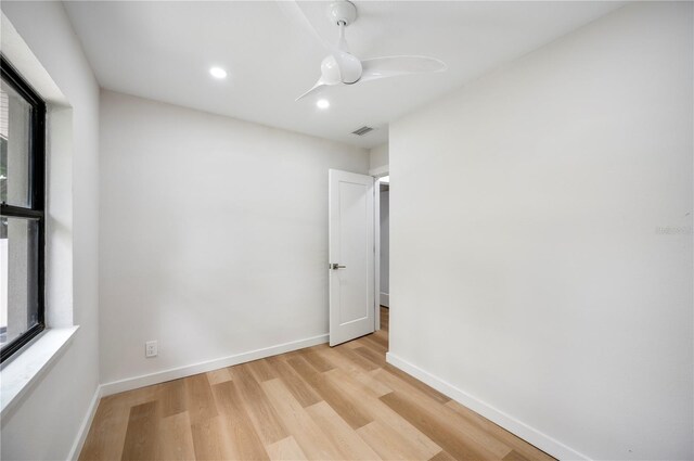 unfurnished room with ceiling fan and light wood-type flooring