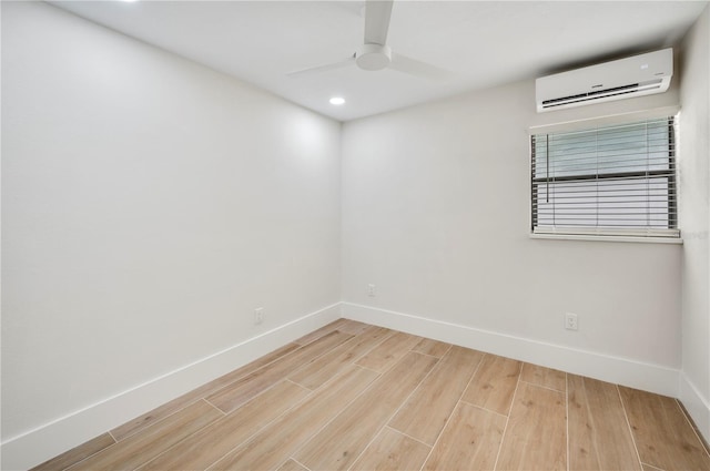 unfurnished room with a wall unit AC and ceiling fan