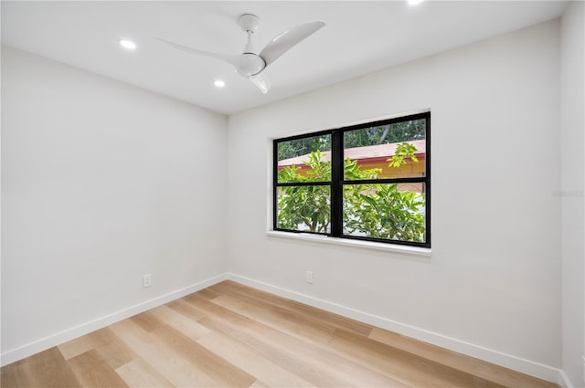 spare room featuring light hardwood / wood-style flooring and ceiling fan