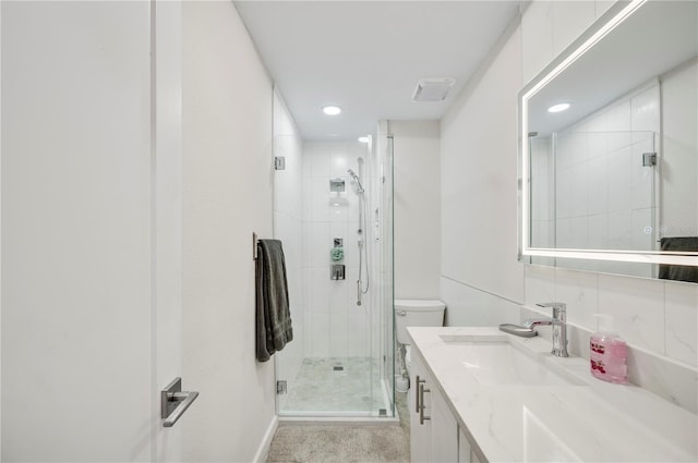 bathroom with vanity, an enclosed shower, and toilet