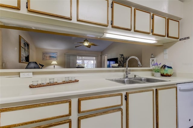 kitchen featuring white dishwasher, white cabinets, lofted ceiling, and sink