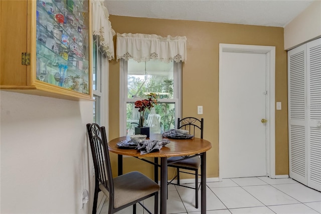 dining space featuring light tile patterned floors