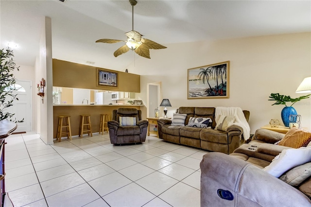 tiled living room featuring ceiling fan and high vaulted ceiling