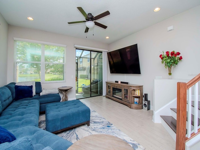 living room with ceiling fan and wood-type flooring