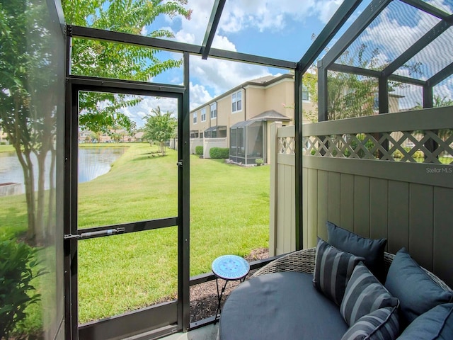 sunroom / solarium featuring a water view