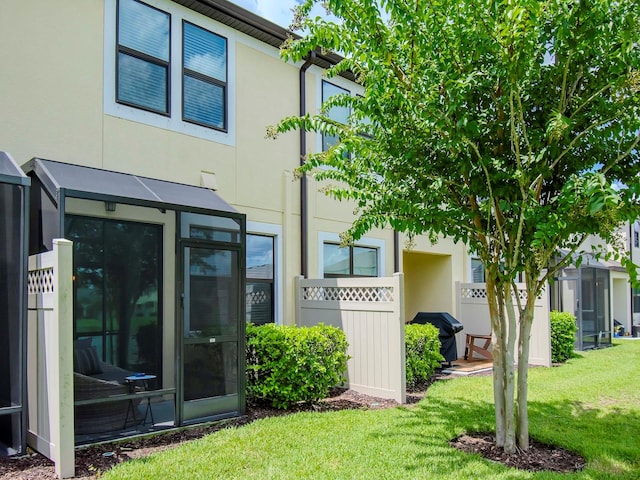 rear view of house featuring a yard