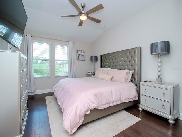 bedroom with vaulted ceiling, ceiling fan, and dark hardwood / wood-style flooring