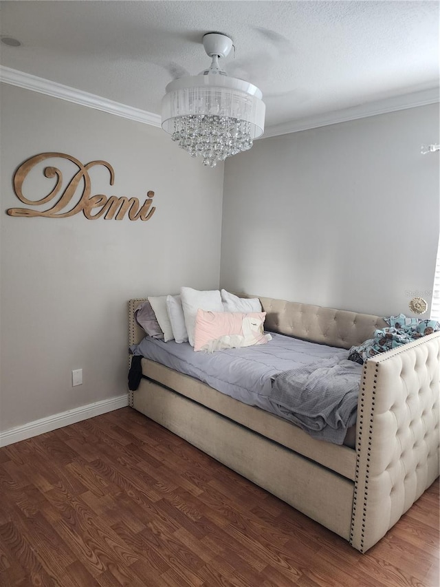 bedroom featuring hardwood / wood-style flooring and crown molding