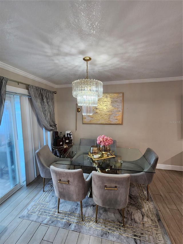 dining area featuring crown molding, a textured ceiling, and hardwood / wood-style floors