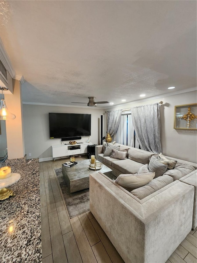 living room featuring ornamental molding, light hardwood / wood-style flooring, and ceiling fan