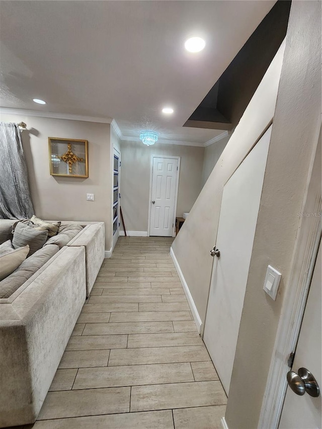 hallway featuring crown molding and light hardwood / wood-style flooring