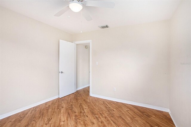 unfurnished room with ceiling fan and hardwood / wood-style floors