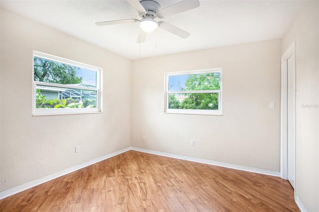 empty room with light hardwood / wood-style floors and ceiling fan