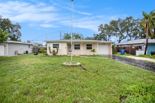 ranch-style house with a garage and a front yard