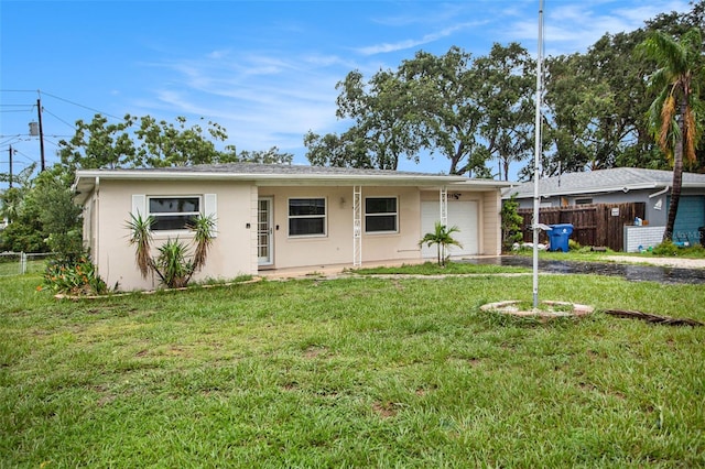 single story home featuring a garage and a front lawn