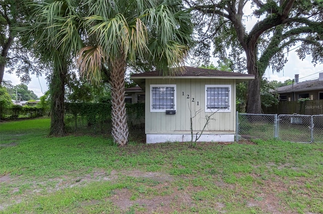 view of outbuilding featuring a lawn