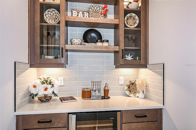 bar with beverage cooler and tasteful backsplash