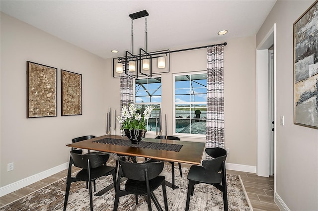 dining space with dark wood-type flooring and a chandelier