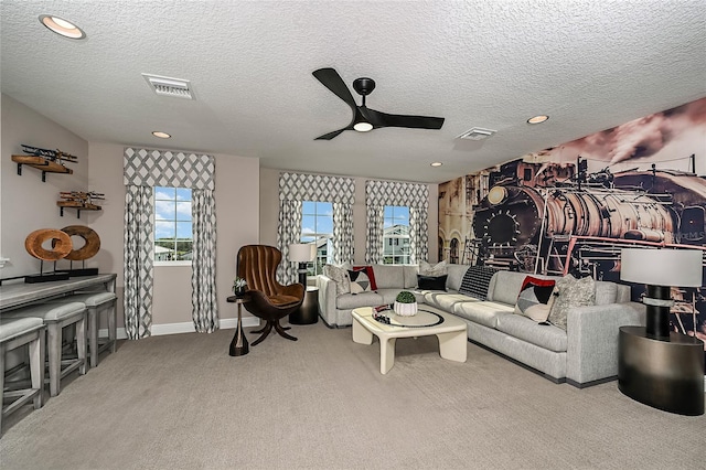 living room featuring a textured ceiling, light colored carpet, and ceiling fan