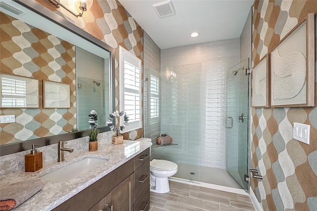 bathroom with vanity, an enclosed shower, tile patterned flooring, and toilet