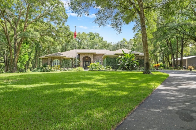 single story home with a front lawn