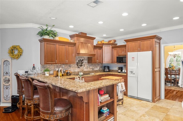 kitchen featuring black appliances, crown molding, light hardwood / wood-style flooring, custom range hood, and kitchen peninsula