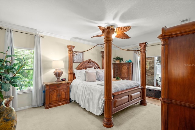 carpeted bedroom with ceiling fan, a textured ceiling, and ornamental molding