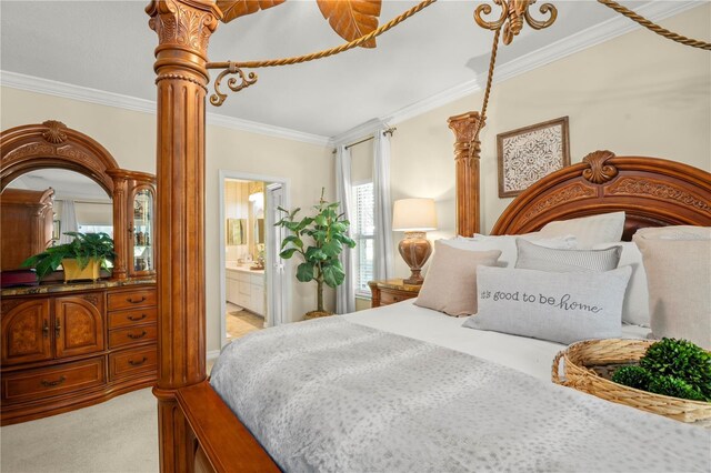 carpeted bedroom with ensuite bathroom and ornamental molding