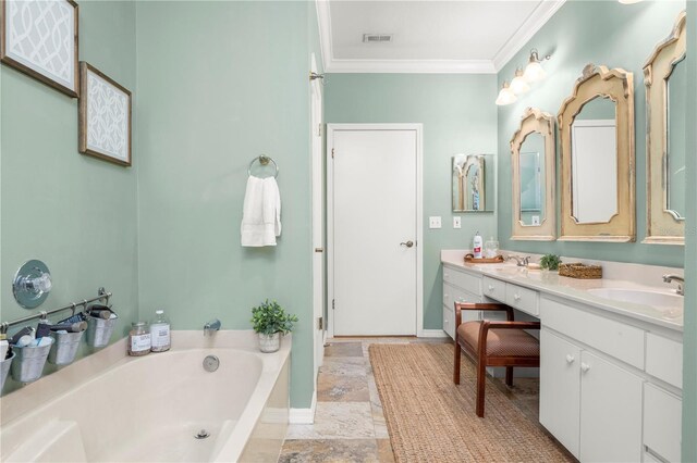 bathroom with a tub, vanity, and ornamental molding