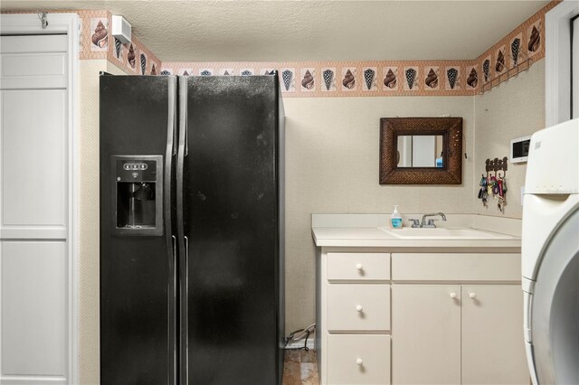 bathroom featuring vanity and a textured ceiling