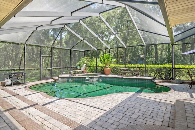 view of pool with a patio and a lanai