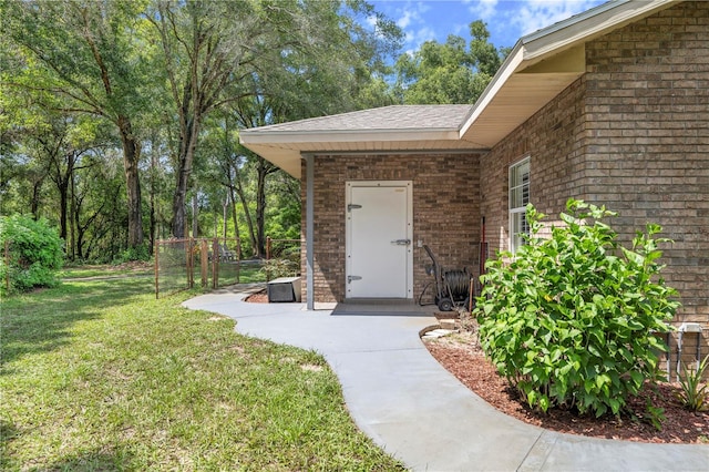 doorway to property featuring a lawn