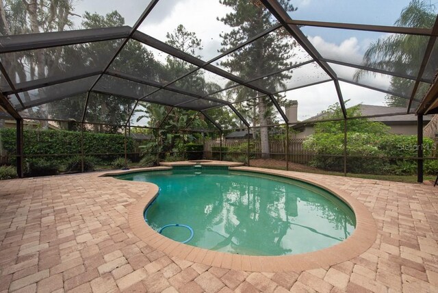 view of pool with a lanai and a patio area