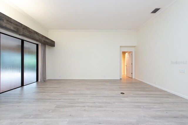 unfurnished room featuring ornamental molding and light hardwood / wood-style floors