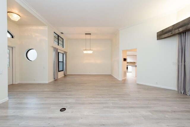 unfurnished living room with light hardwood / wood-style floors and plenty of natural light