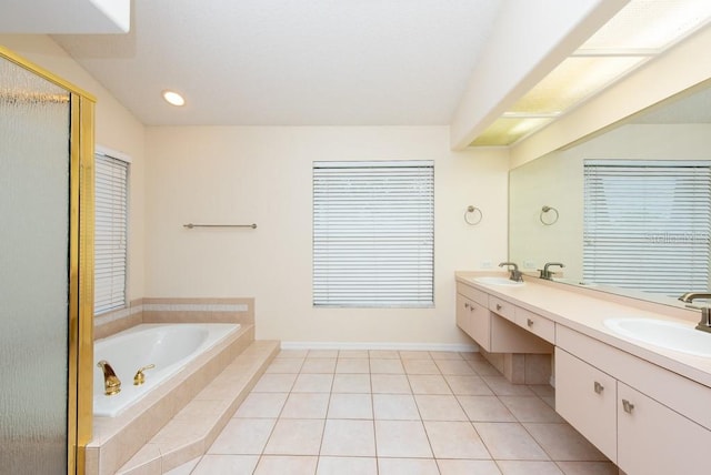 bathroom with tiled tub, tile patterned floors, and double sink vanity