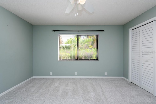 unfurnished bedroom featuring a closet, carpet floors, and ceiling fan