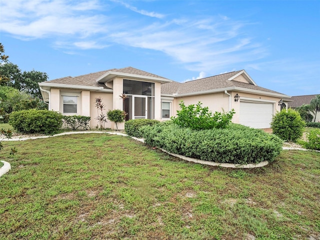 ranch-style home featuring a garage and a front lawn