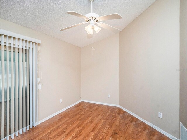 spare room with a textured ceiling, hardwood / wood-style floors, and ceiling fan