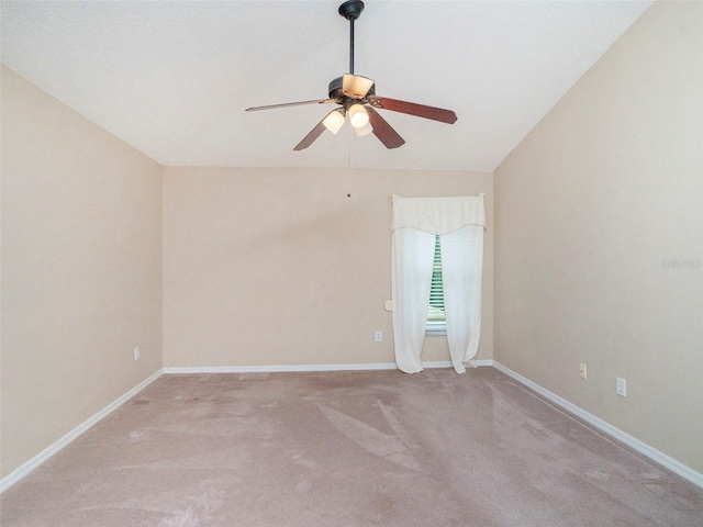 unfurnished room with carpet flooring, vaulted ceiling, and ceiling fan