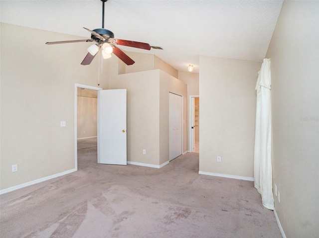 interior space with high vaulted ceiling, ceiling fan, and light colored carpet