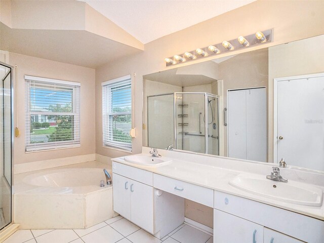 bathroom with shower with separate bathtub, tile patterned floors, vaulted ceiling, and dual bowl vanity