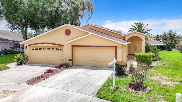 single story home with a garage and a front lawn