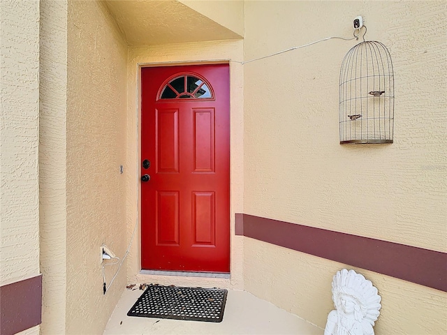 entrance to property with stucco siding