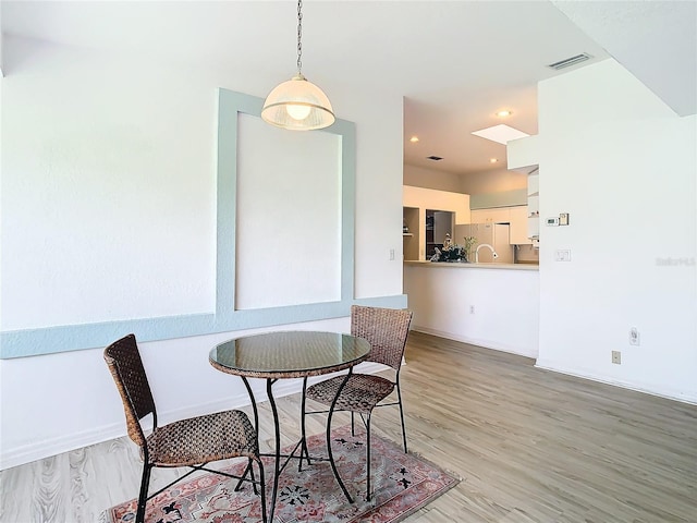 dining room with recessed lighting, wood finished floors, visible vents, and baseboards