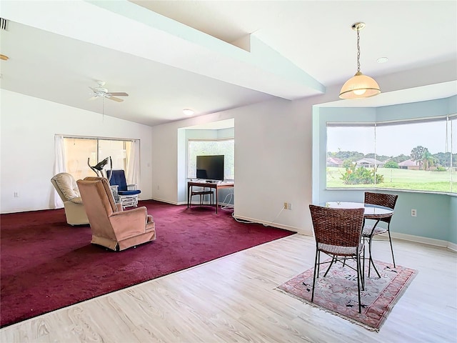 living room with vaulted ceiling, wood finished floors, a ceiling fan, and baseboards