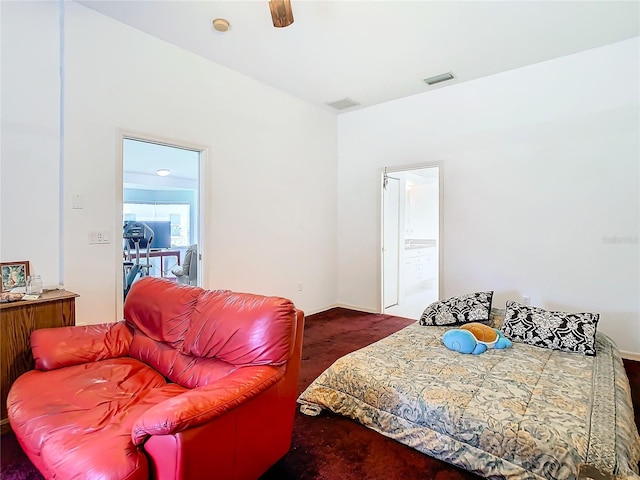 bedroom featuring dark colored carpet, connected bathroom, and visible vents