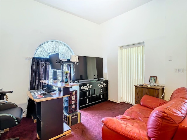 living room featuring dark carpet and baseboards