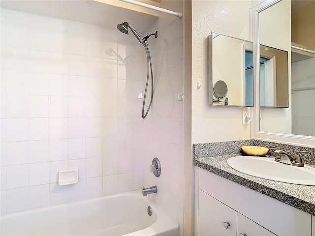 bathroom featuring vanity and tiled shower / bath combo