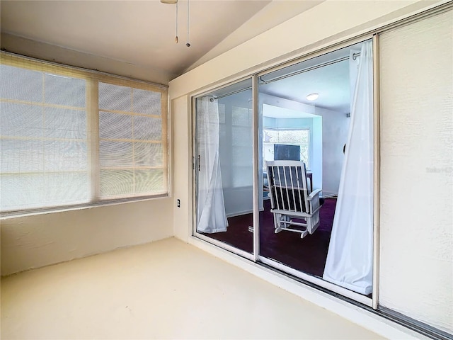 unfurnished sunroom featuring vaulted ceiling